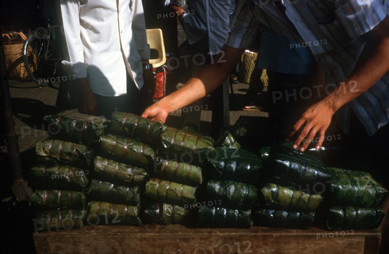 VIETNAM, Ho Chi Minh City, Tet delicacy of rice wrapped in banana leaves and steamed.