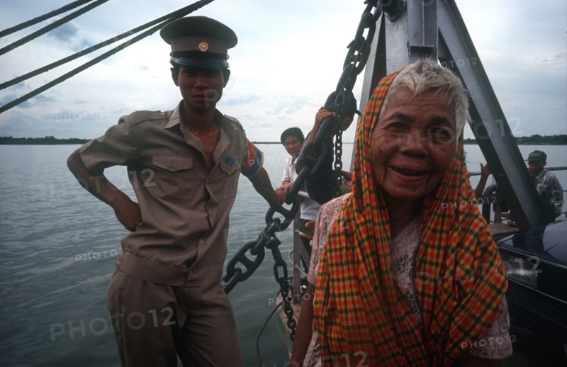CAMBODIA, Neak Long, "Passengers on the Mekong ferry, old woman and soldier. "