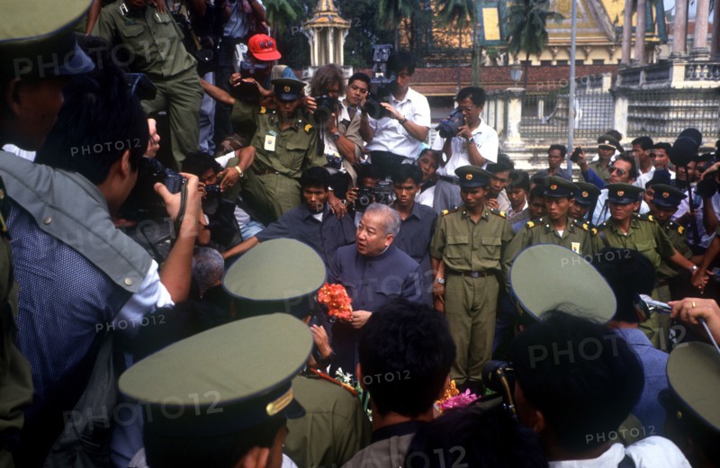 CAMBODIA, Phnom Pehn, "Sihanouk surrounded by crowds, journalists and troops at the Silver Pagoda."