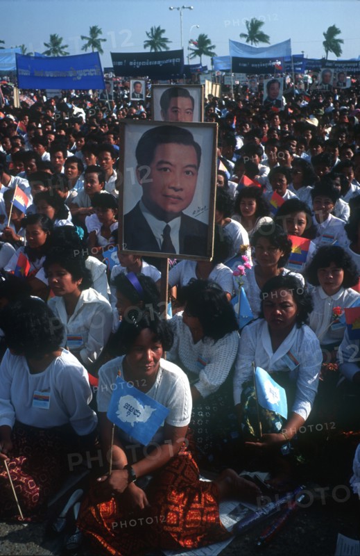 CAMBODIA, Phnom Pehn, "Crowds awaiting the arrival of Sihanouk outside the Royal Palace, many holding flags and posters."