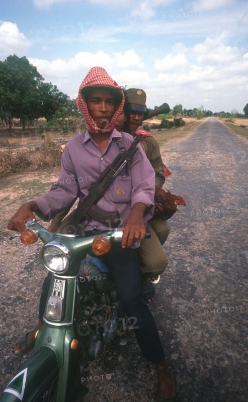 CAMBODIA, Kompong Thom, Motorbike army patrol on National Route 6.
