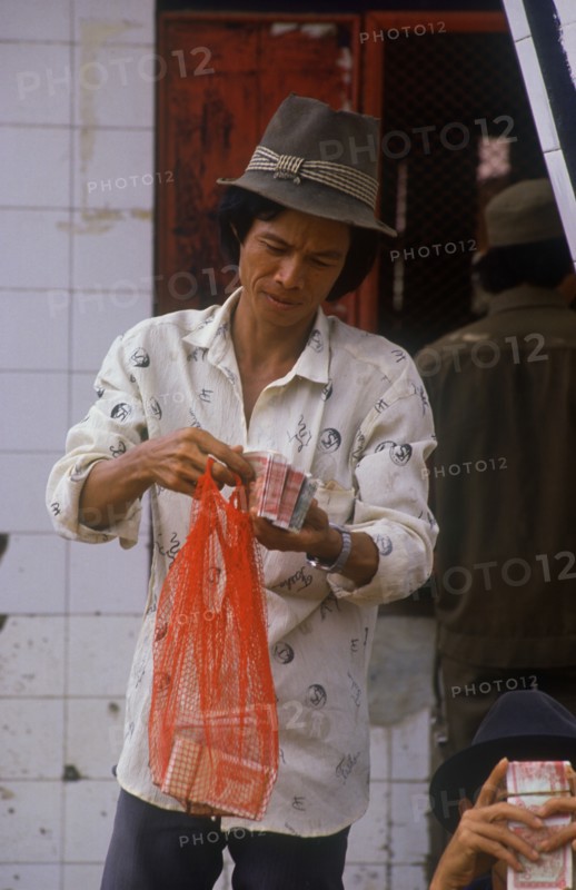 CAMBODIA, Neak Long, Money changer at the Neak Long ferry.