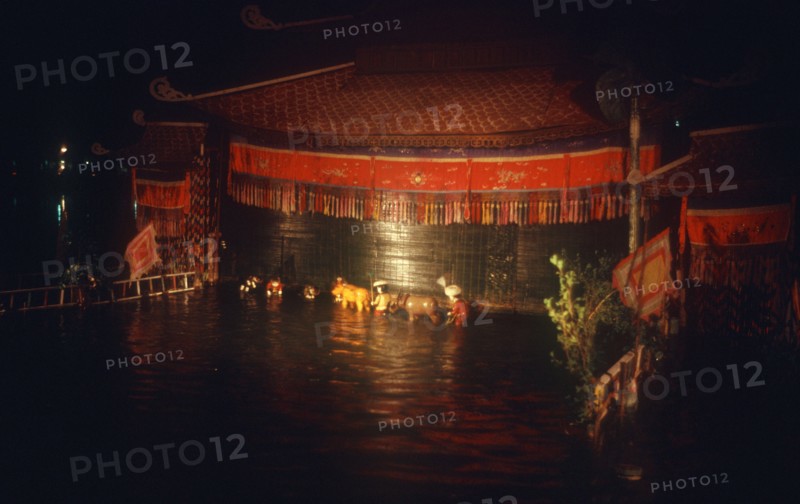 VIETNAM, Hanoi, Water puppet theatre on Petit Lake at night.