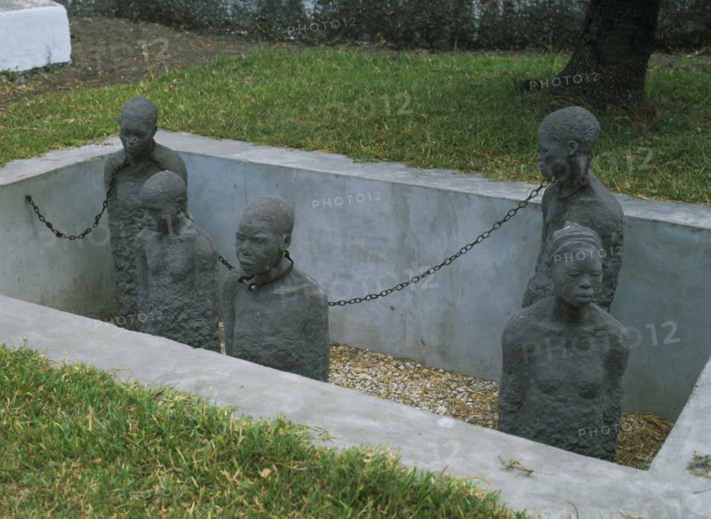 TANZANIA, Zanzibar Island, Zanzibar, Stone Town. Sculpture depicting five slaves chained in a pit in the grounds of the Cathedral Church of Christ Anglican Cathedral.