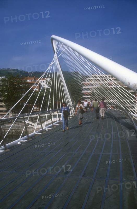 SPAIN, Basque Provinces, Vizcaya Province, Bilbao.  The Zubuzuri footbridge with people crossing.