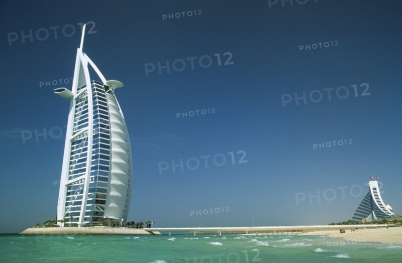 UAE, Dubai, The Burj-al-Arab Hotel with the Jumeirah Beach Hotel in the distance behind.