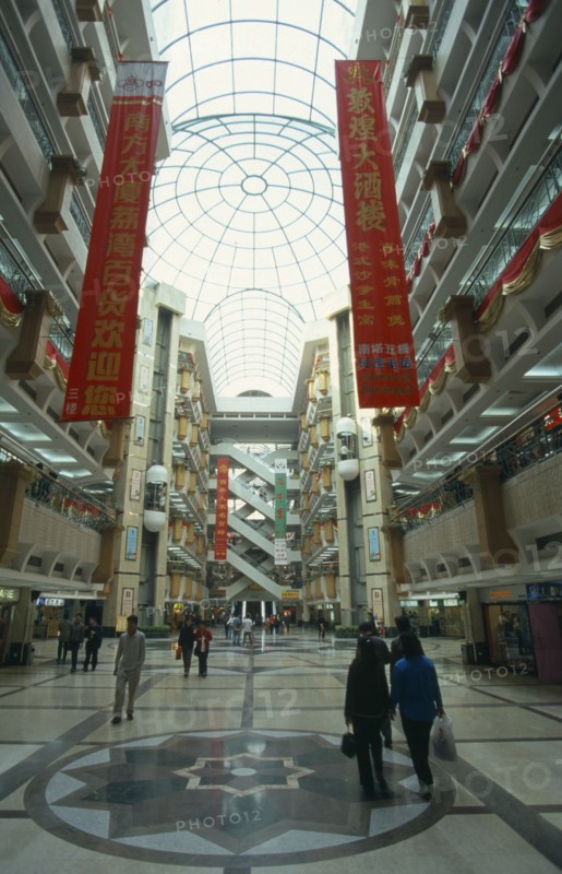 CHINA, Guangdong Province, Guangzhou, Multi level shopping centre interior with domed glass roof.