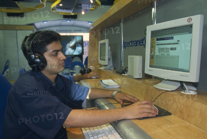 INDIA, Uttar Pradesh , New Dehli, Young man using the internet.