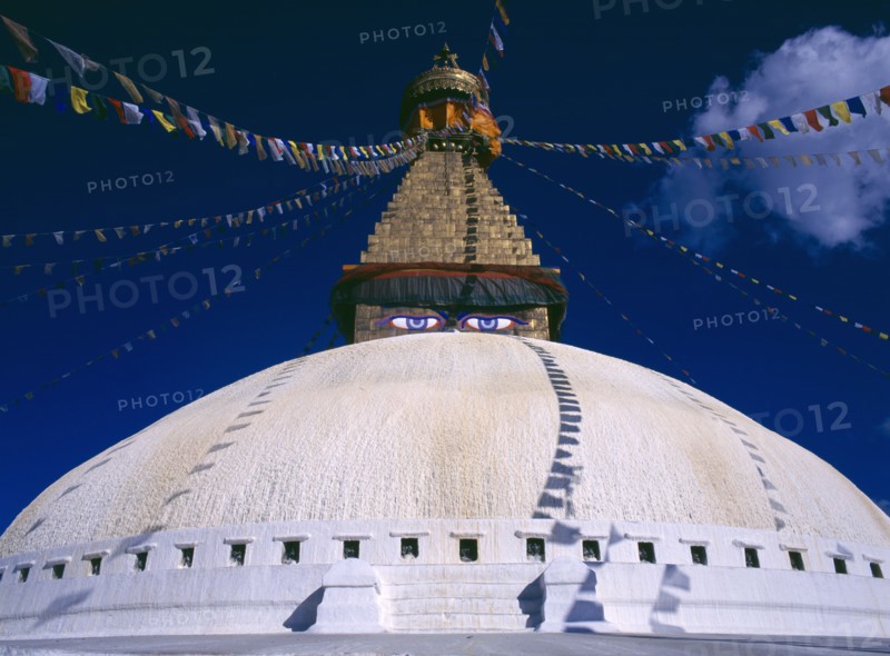 NEPAL, Kathmandu, Bodhnath stupa hung with prayer flags.