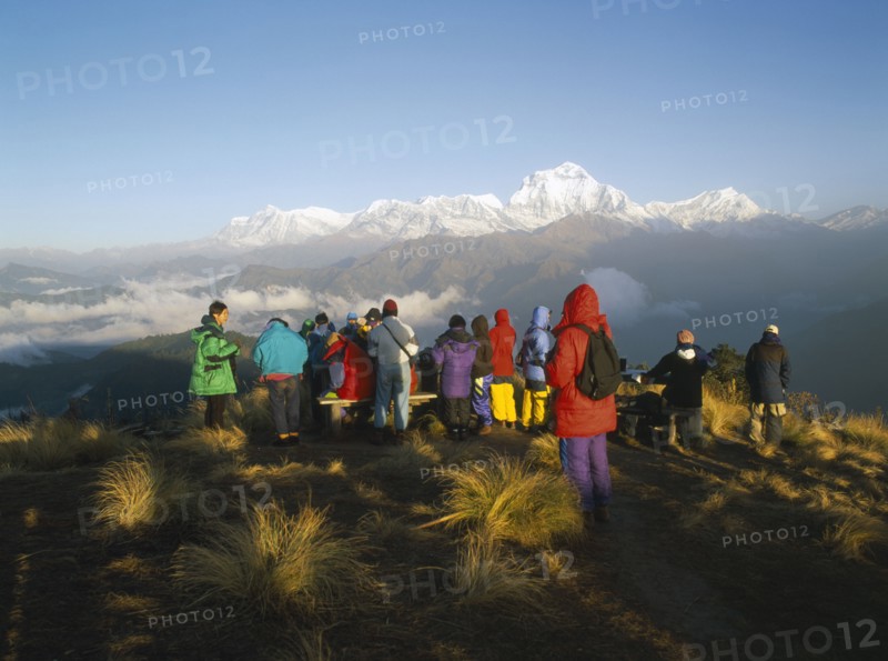 NEPAL, Annapurna Region, Poon Hill, Trekkers gathered to watch the sunrise over the Annapurna mountain range.