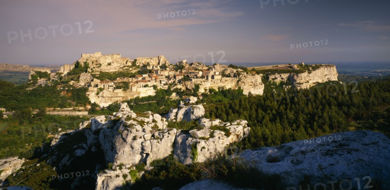 FRANCE, Provence-Cote d’Azur, Les Baux de Provence, View over rocky outcrop towards fortified hill town.  Bouches du Rhone.