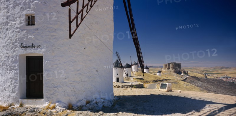 SPAIN, Castilla La Mancha, Line of white painted windmills.