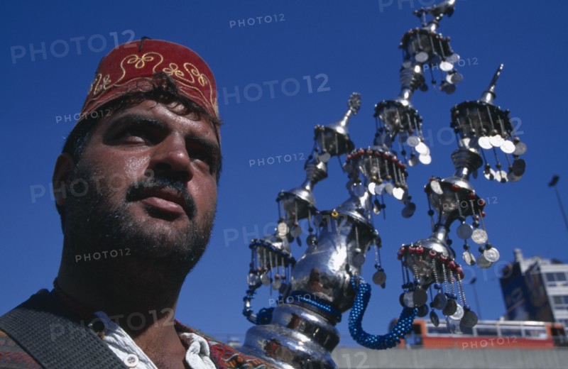 SYRIA, South , Damascus, "Drink vendor, cropped view with decorative water container."