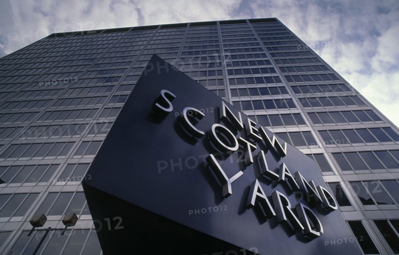 SOCIETY, Law and Order, Police, New Scotland Yard rotating sign with the London Metropolitan Police headquarters behind