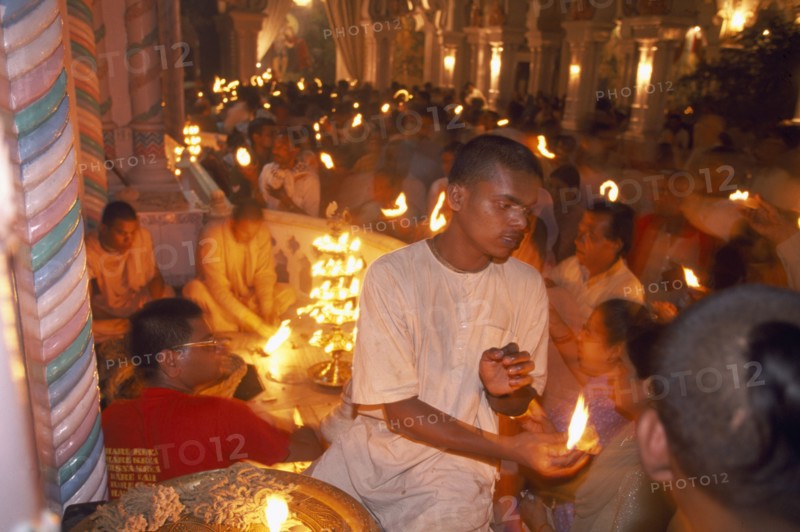 INDIA, Utter Pradesh, Vrindaven, "Dirwali festival, crowds of worshippers holding lighted candles inside temple.  "