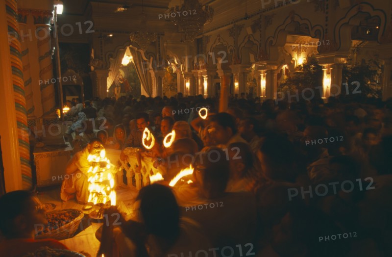 INDIA, Utter Pradesh, Vrindaven, "Dirwali festival, crowds of worshippers holding lighted candles in dark temple interior.  "