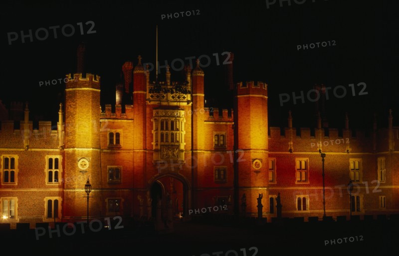 ENGLAND, London, Hampton Court, View of exterior facade illuminated at night.
