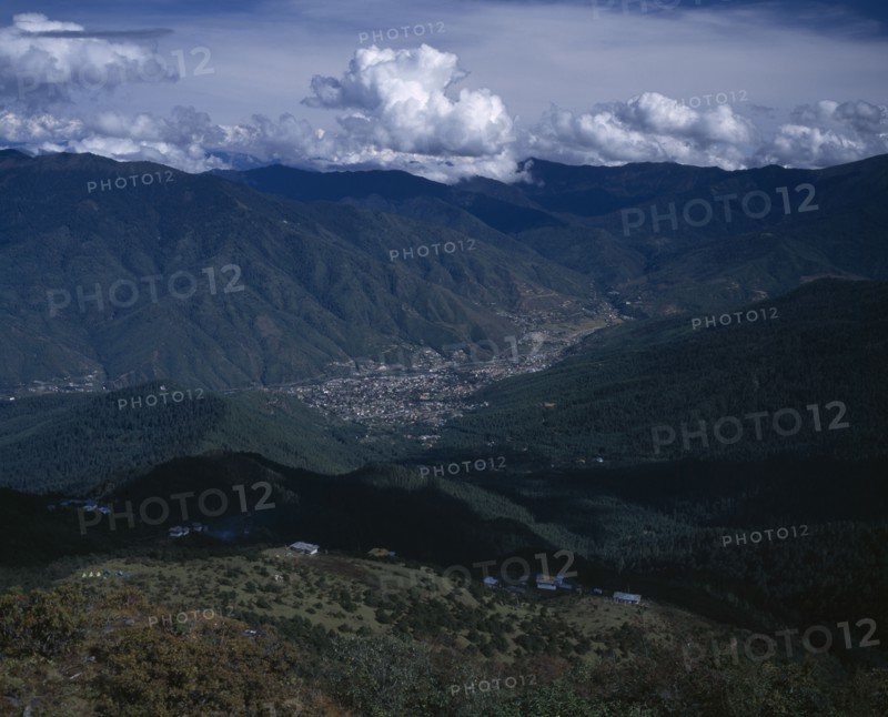 BHUTAN, Thimphu, "View from above across city, valley and surrounding mountains."