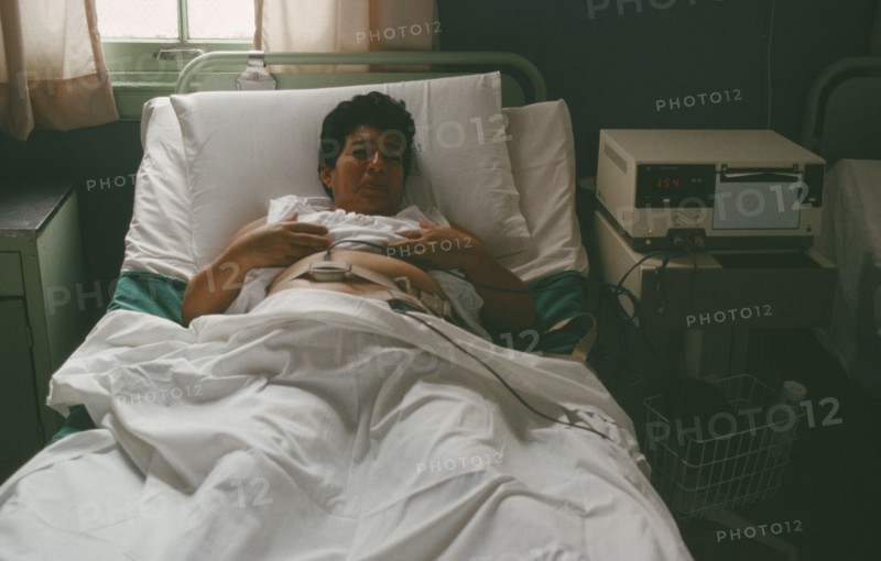 CUBA, Havana, Pregnant mother in hospital bed attached to monitor