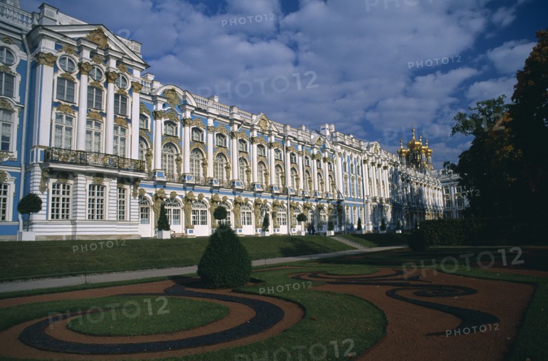 RUSSIA, Pushkin, "Catherine Palace.  View across formal gardens towards blue, white and gold painted exterior. "