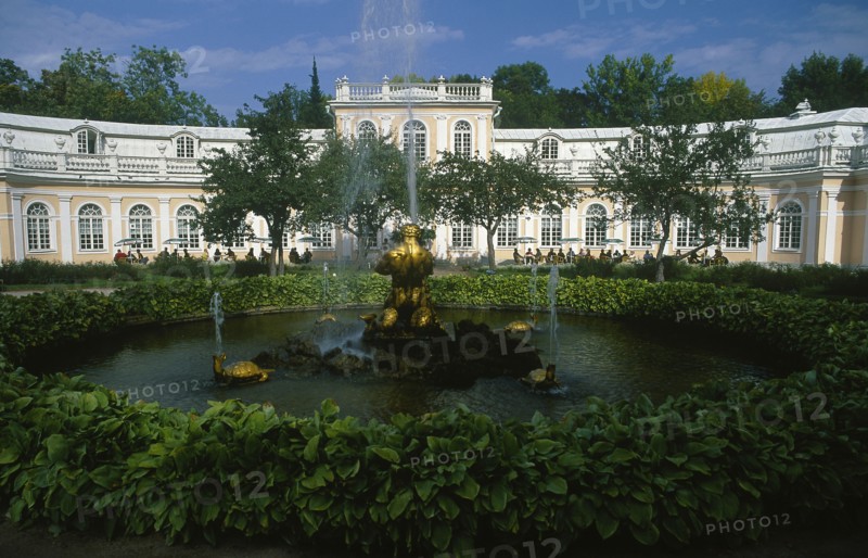 RUSSIA, St. Petersburg, Peterhof Palace grounds.  The Orangerie in the lower gardens with circular pond and fountain in the foreground.