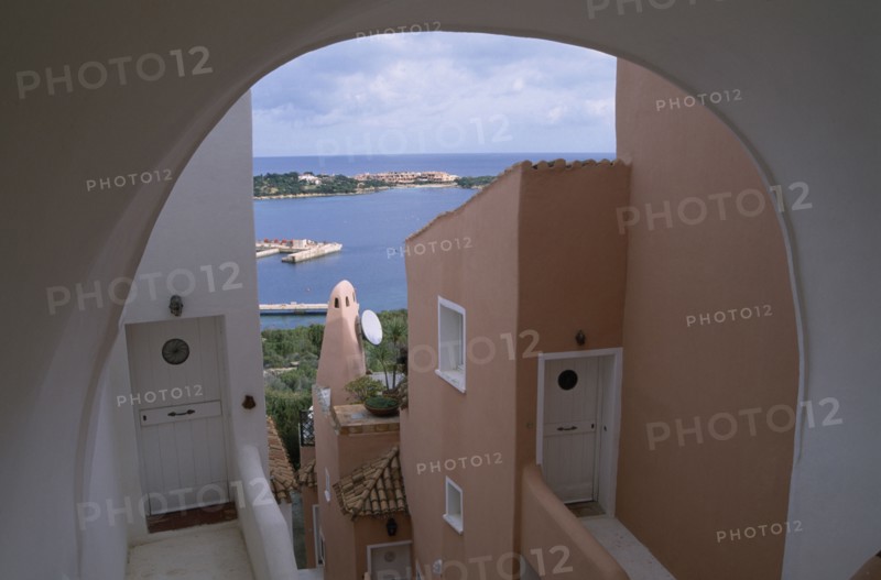 ITALY, Sardinia, Costa Smeralda, "Porto Cervo brightly painted apartment alley way, looking out over the harbour. "