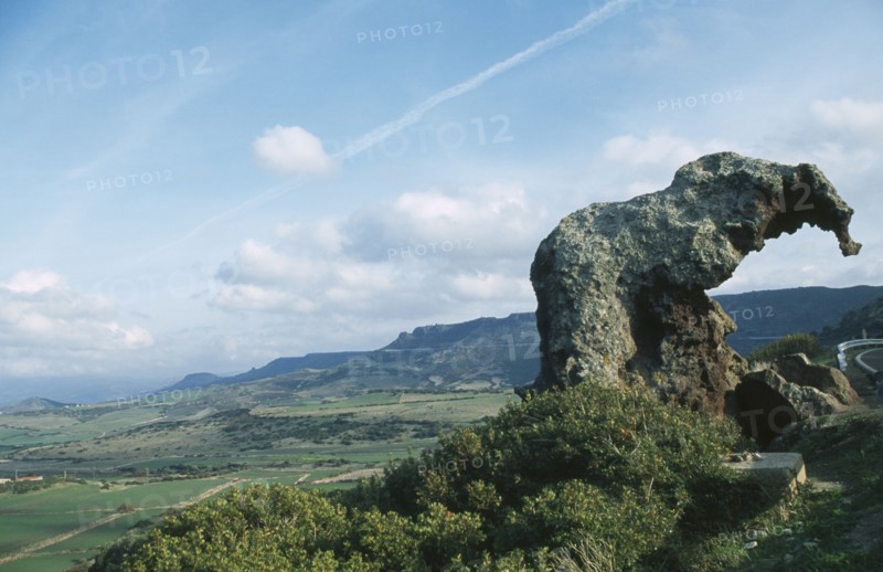 ITALY, Sardinia, Near Castelsardo. View of Elephant Rock in landscape over looking fields and hills.