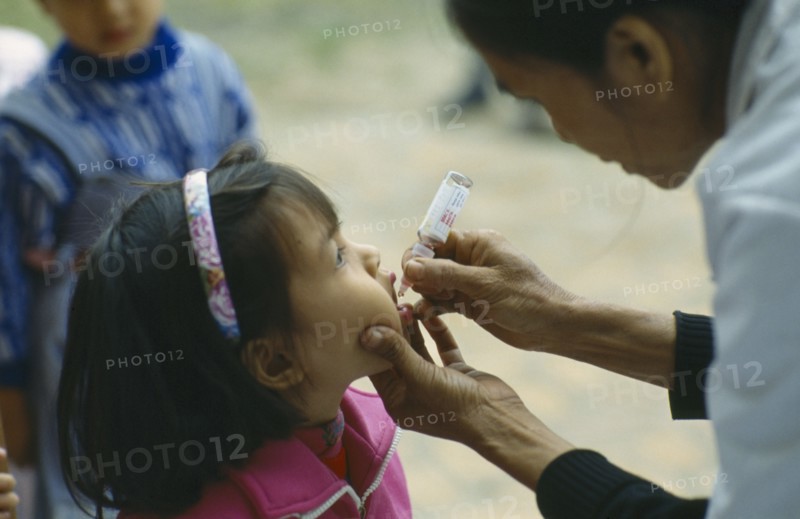 VIETNAM, North, General, Primary school pupil receiving oral polio immunization.