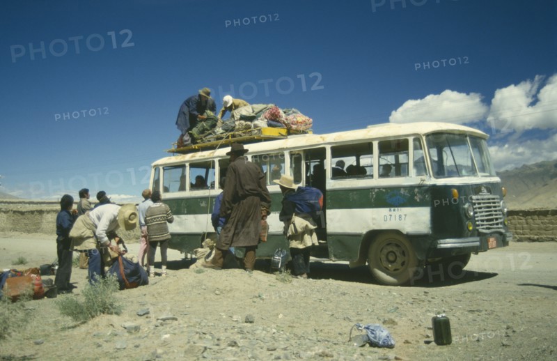 TIBET, Tranport, Bus, Bus in the countryside being loaded with goods by passengers