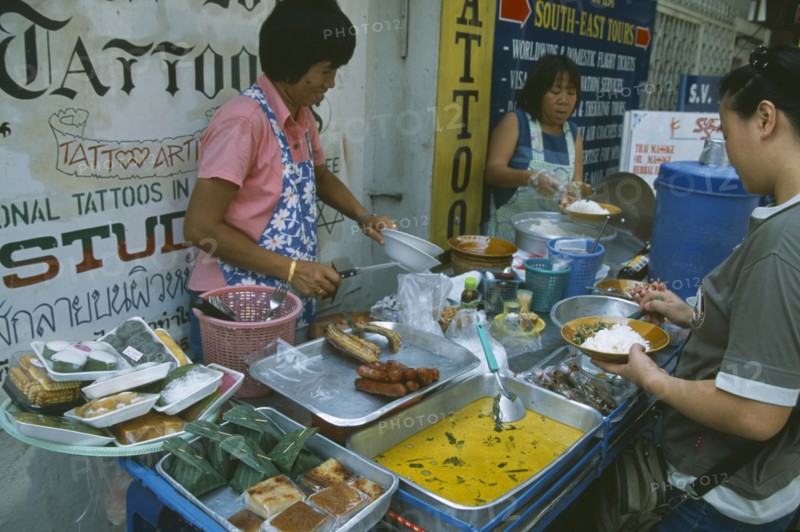 THAILAND, Bangkok, Khao San Road, Women serving various curries from a pavement stall