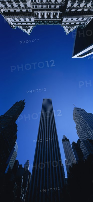USA, New York State, New York, Midtown architecture seen from below looking upwards against cloudless blue sky.