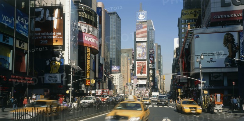USA, New York, Manhattan, "Times Square.  Daytime view with traffic and advertising hoardings, speeding yellow cabs in the foreground."