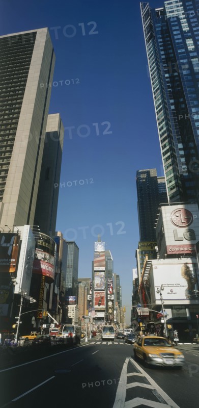 USA, New York, Manhattan, "Times Square.  Daytime view with traffic and advertising hoardings, speeding yellow cabs in the foreground."