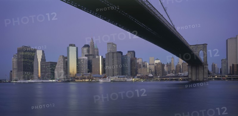 USA, New York State, New York, Lower Manhattan.  Post September 11 skyline from Brooklyn at dusk with Brooklyn Bridge in the foreground.