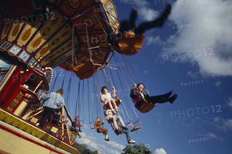 ENTERTAINMENT, Fun-fair, Angled view of children on ride at London funfair.