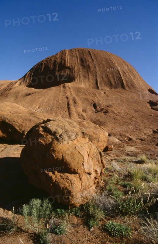 AUSTRALIA, Northern Territory, Uluru, "Ayers Rock, view towards rock with large circular boulder in the foreground."