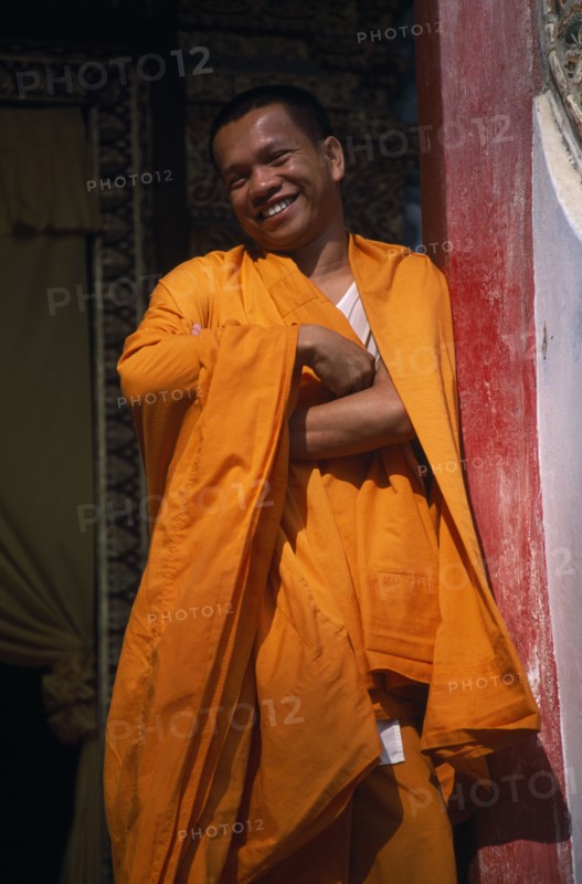 THAILAND, North, Chiang Mai, Wat Tung Yu temple hall with Buddhist monk laughing