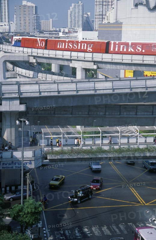 THAILAND, Bangkok, Sky Train above pedestrian walkways and road traffic at the junction of Rama 1 and Phaya Thai Road