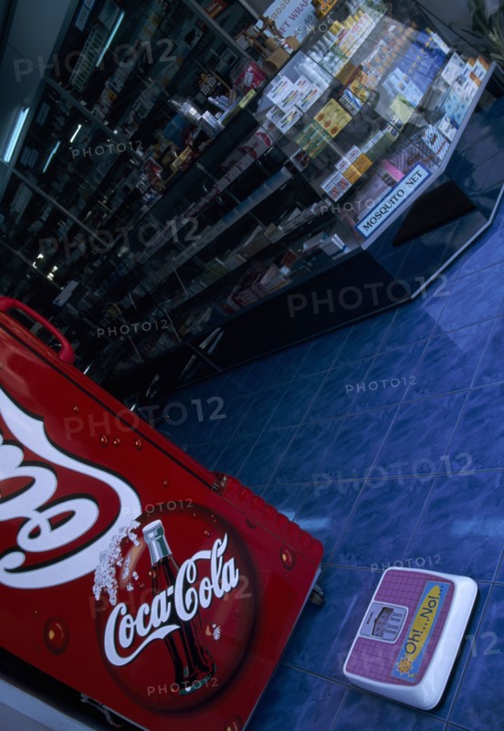 THAILAND, North, Chiang Mai, Pharmacy with Coca Cola fridge and scales on the step  with the words Oh No written on it
