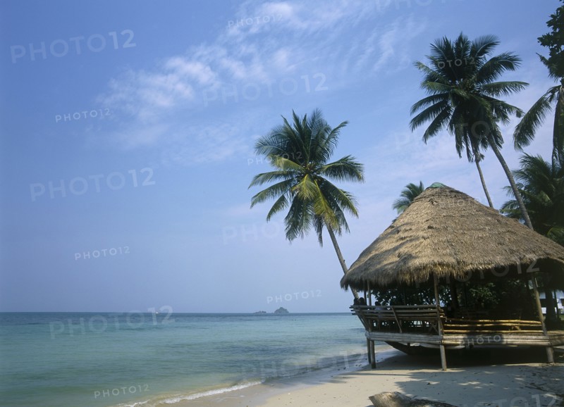 THAILAND, Trat Province, Koh Chang, Kai Bae Beach with thatched hut restaurant at the waters edge.