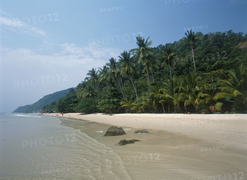 THAILAND, Trat Province, Koh Chang, "White Sand Beach, Haad Sai Khao. View along sandy shore with lush green trees growing inland."