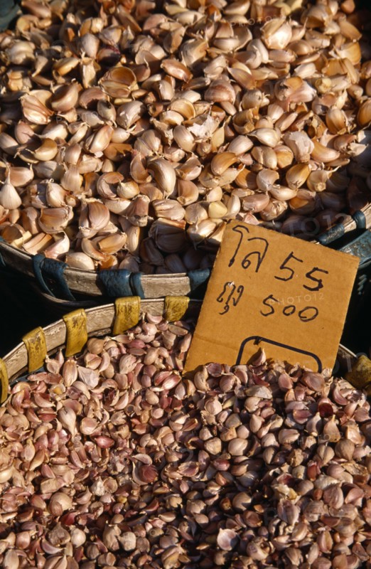 THAILAND, North, Chiang Mai, Wholesale Food Market.  Garlic cloves for sale displayed in woven baskets.