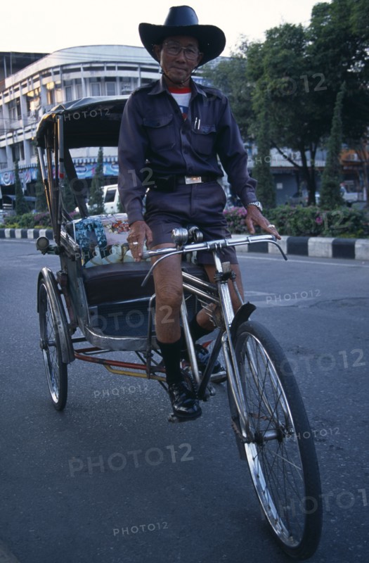 THAILAND, North, Chiang Mai, Cyclo driver on his bike.