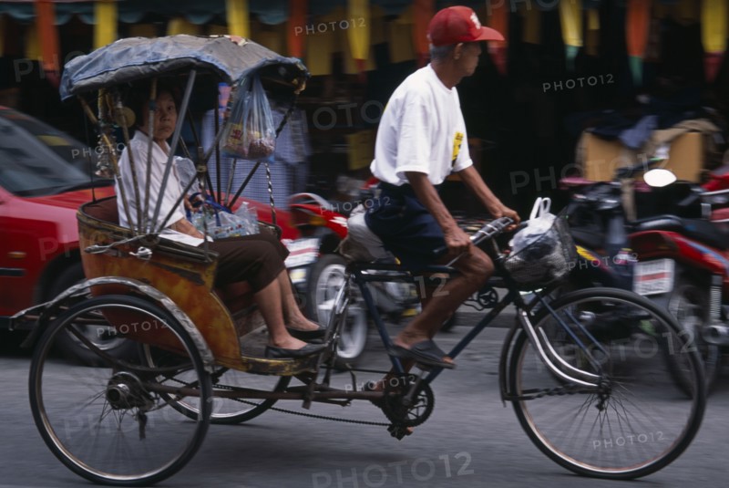 THAILAND, North, Chiang Mai, Cyclo in motion with passenger.