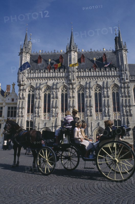 BELGIUM, West Flanders, Bruges, Tourist horse and carriage outside the Stadhuis in Burg Square