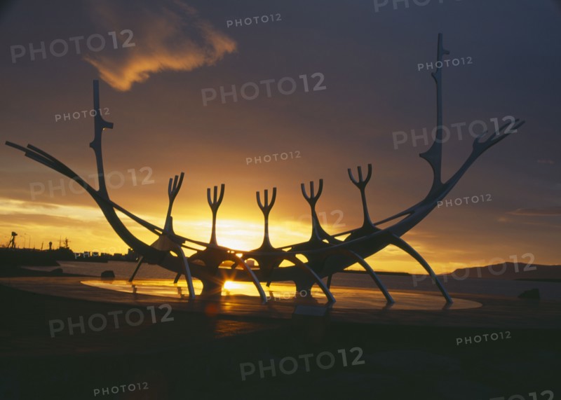 ICELAND, Reykjavik, Sun Voyager or Solfar. 1971 steel Viking ship sculpture by Jon Gunnar Arnason silhouetted at sunset.