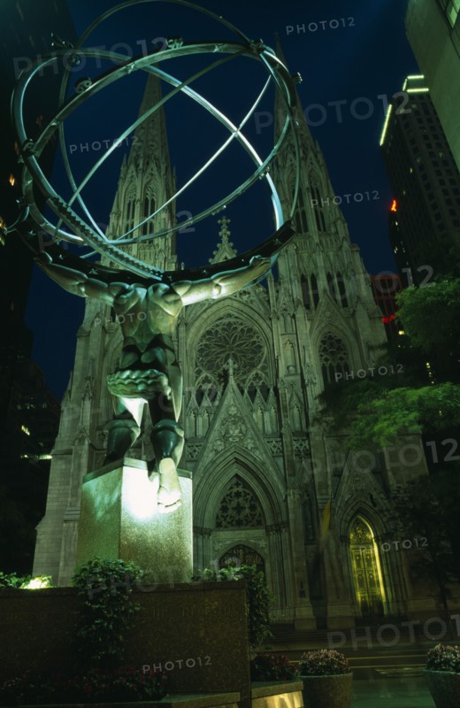 USA, New York, New York City, Atlas and St Patricks Cathedral illuminated at night