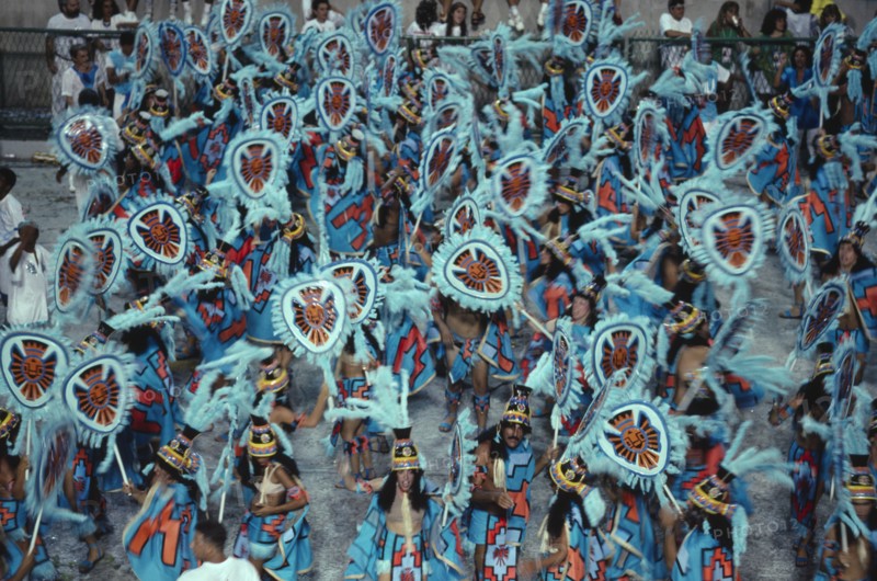 BRAZIL, Rio de Janeiro, Carnival procession of dancers dressed in feathered costumes