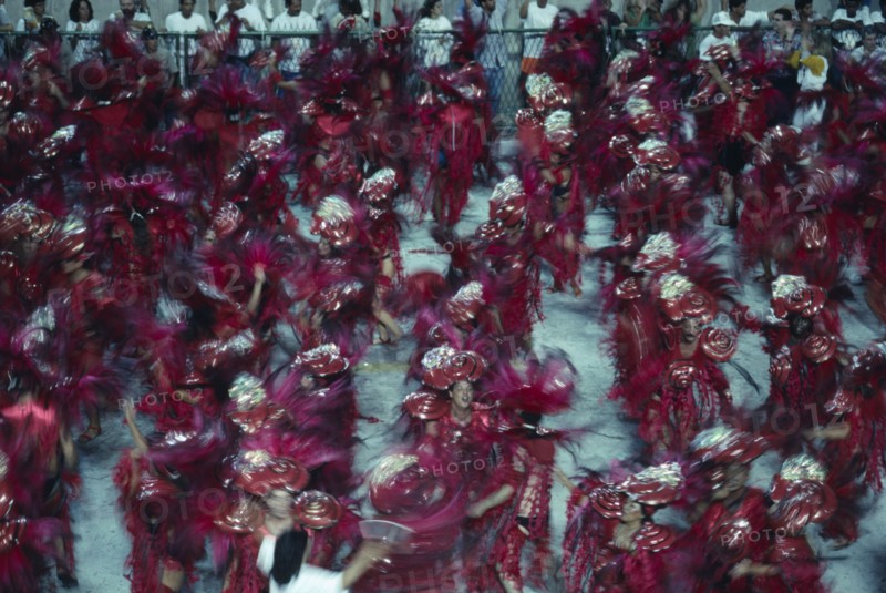 BRAZIL, Rio de Janeiro, Carnival procession of dancers wearing red feathered costumes