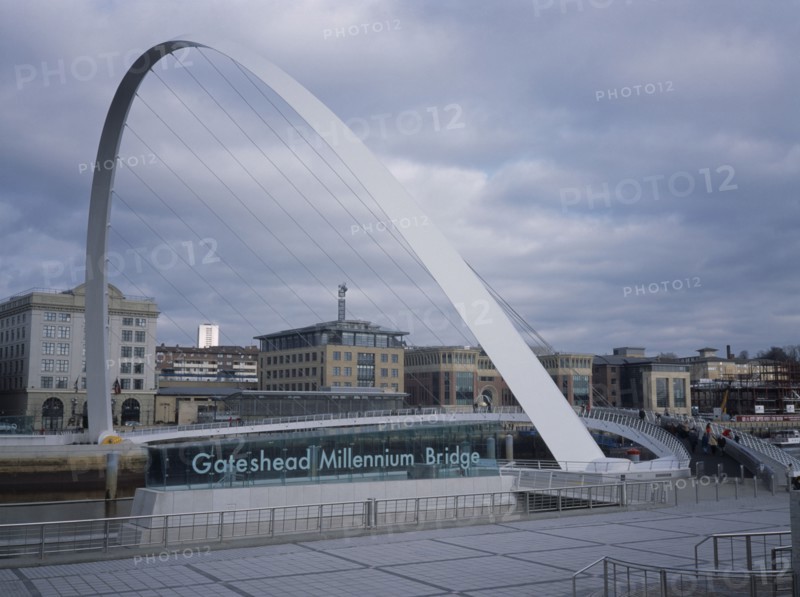 ENGLAND, Tyne and Wear, Gateshead, Millennium Bridge. Large white arch with suspended platform over the River Tyne